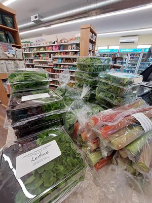 Bagged lettuce, greens and carrots from Lower Piney on display at Good Health Market